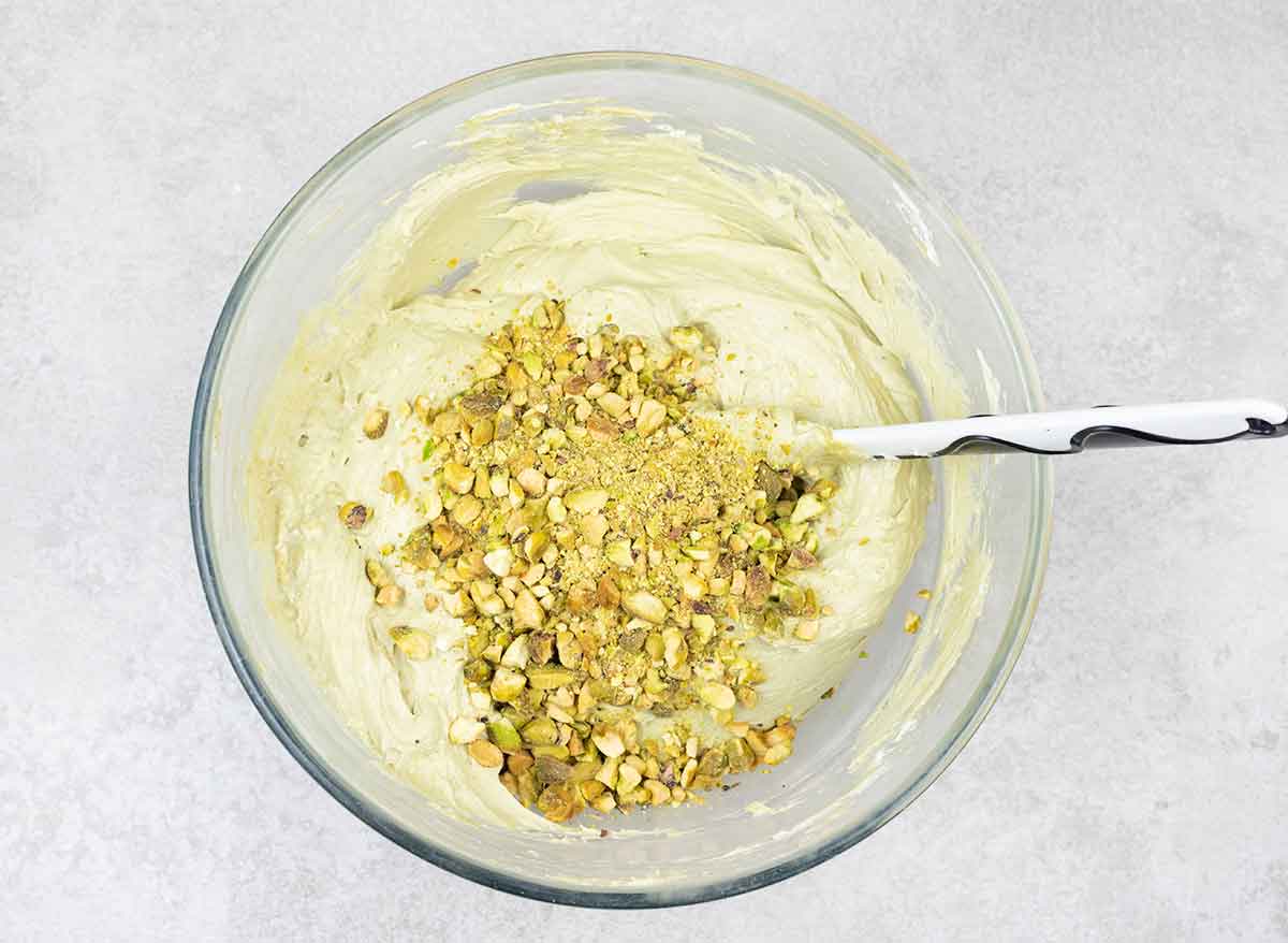 Fold the whipped cream into the cream cheese mixture, then fold in the crushed pistachios.