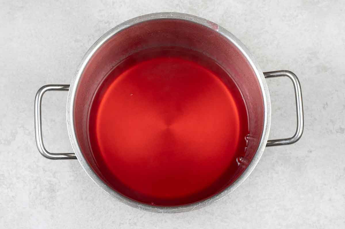 In a small pot, add 350 ml water and bring to a boil, add the strawberry jello, and stir until it dissolves.