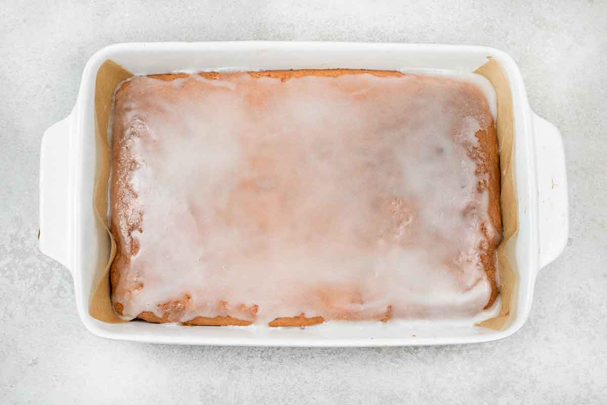 sugar icing on top of a strawberry honey bun cake.