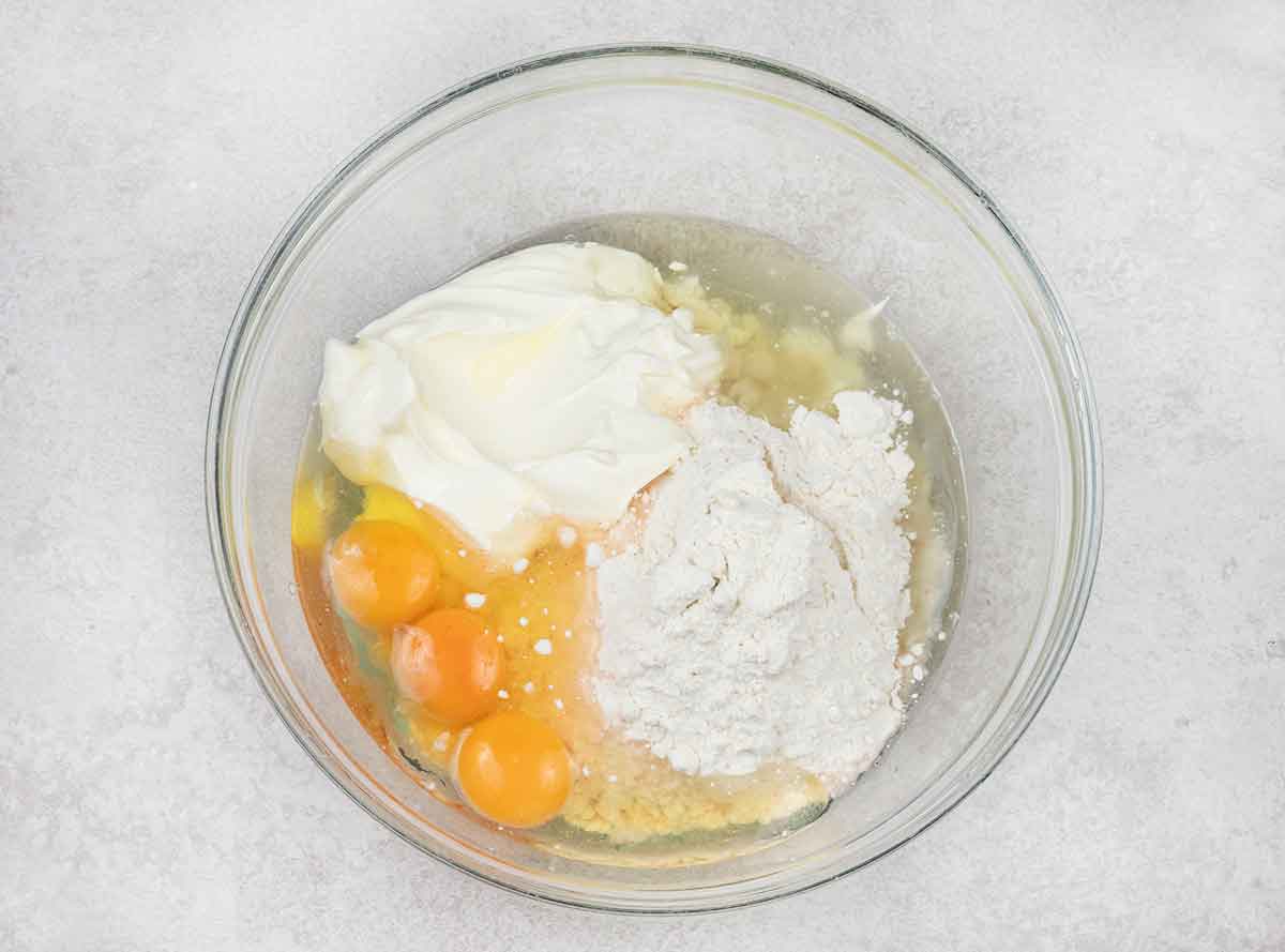 Sour cream, oil, strawberry cake mix and 3 eggs in a large mixing bowl.
