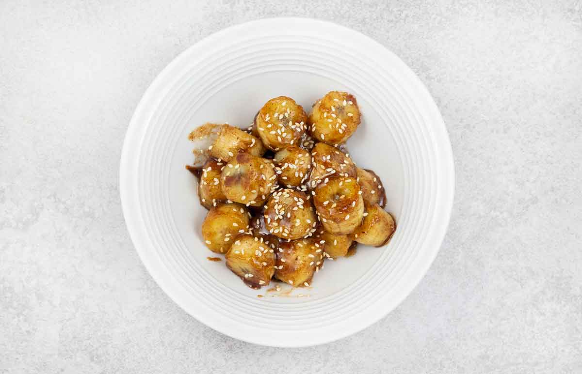 Caramelized banana sliced, topped with sesame seeds.