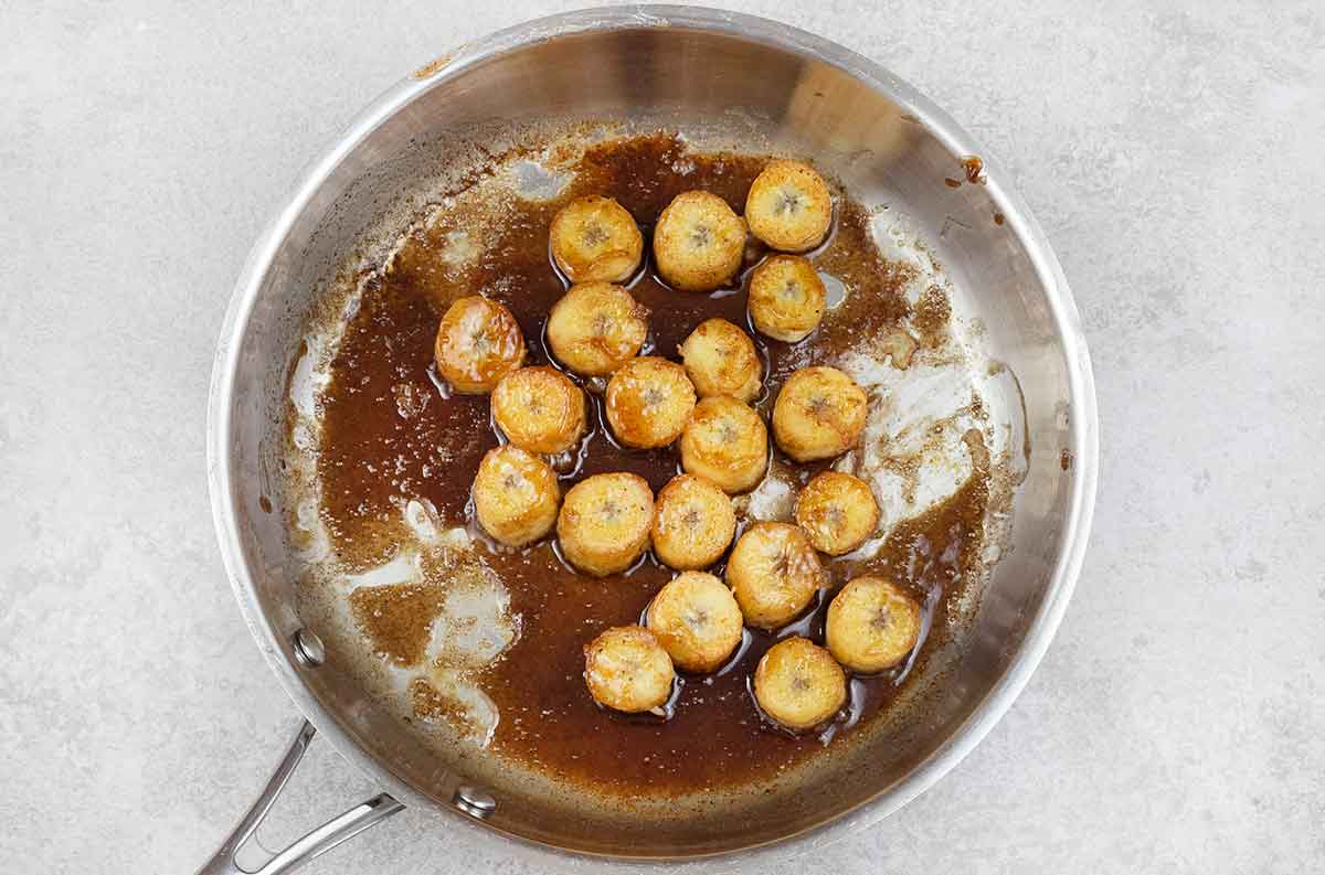 Caramelized banana sliced in a large frying pan.