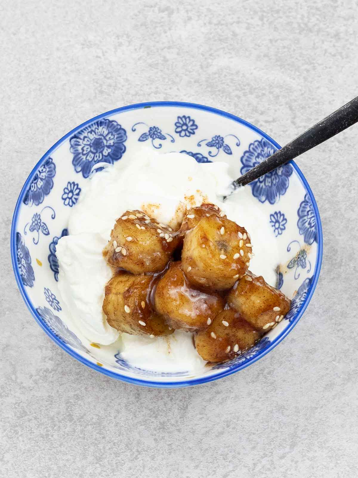Fried bananas on top of yogurt.