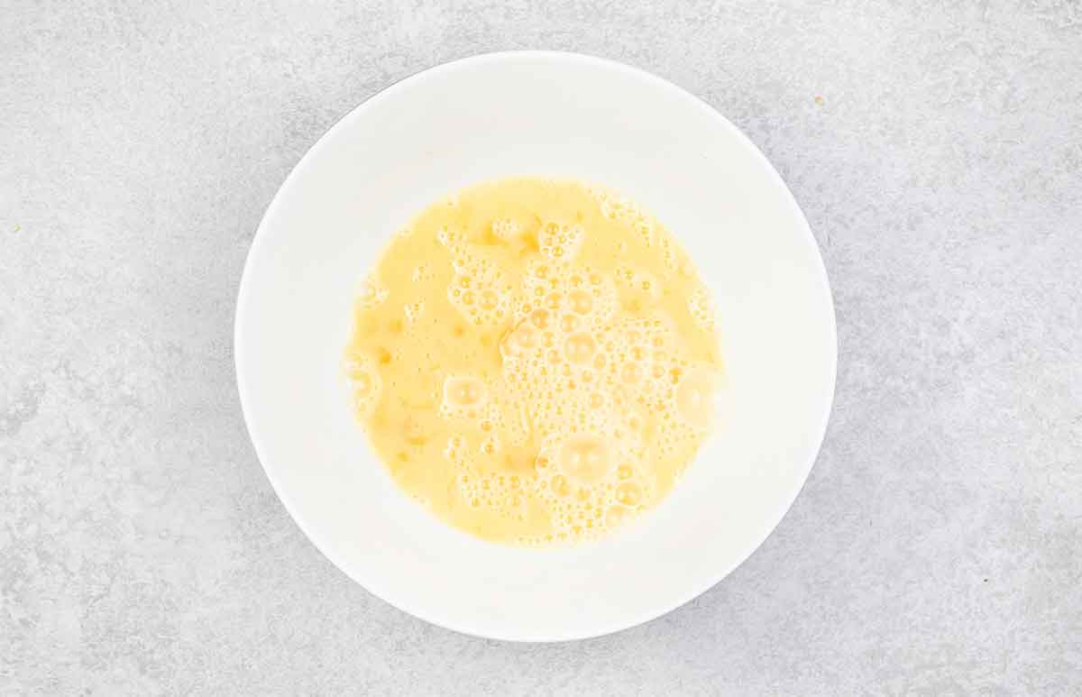 Whisked eggs in a bowl.