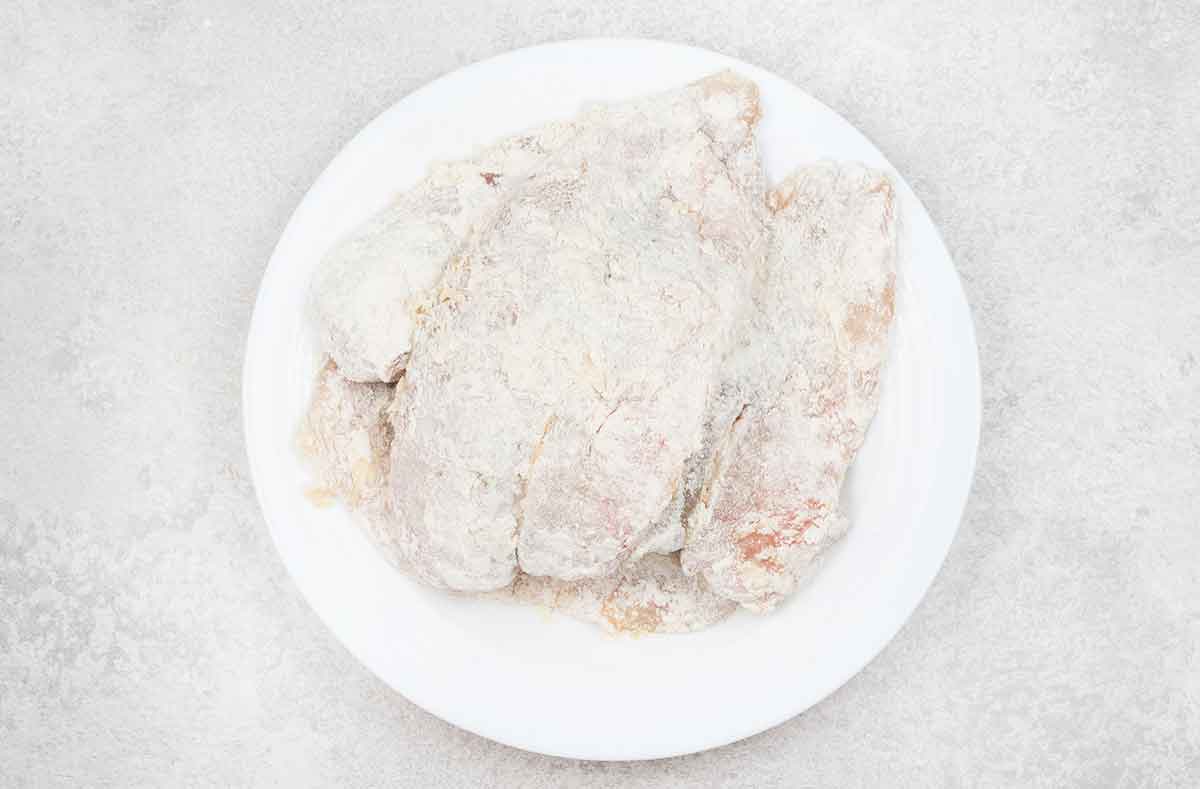 Tilapia fillet dipped in the egg and then dredged in the flour mixture.