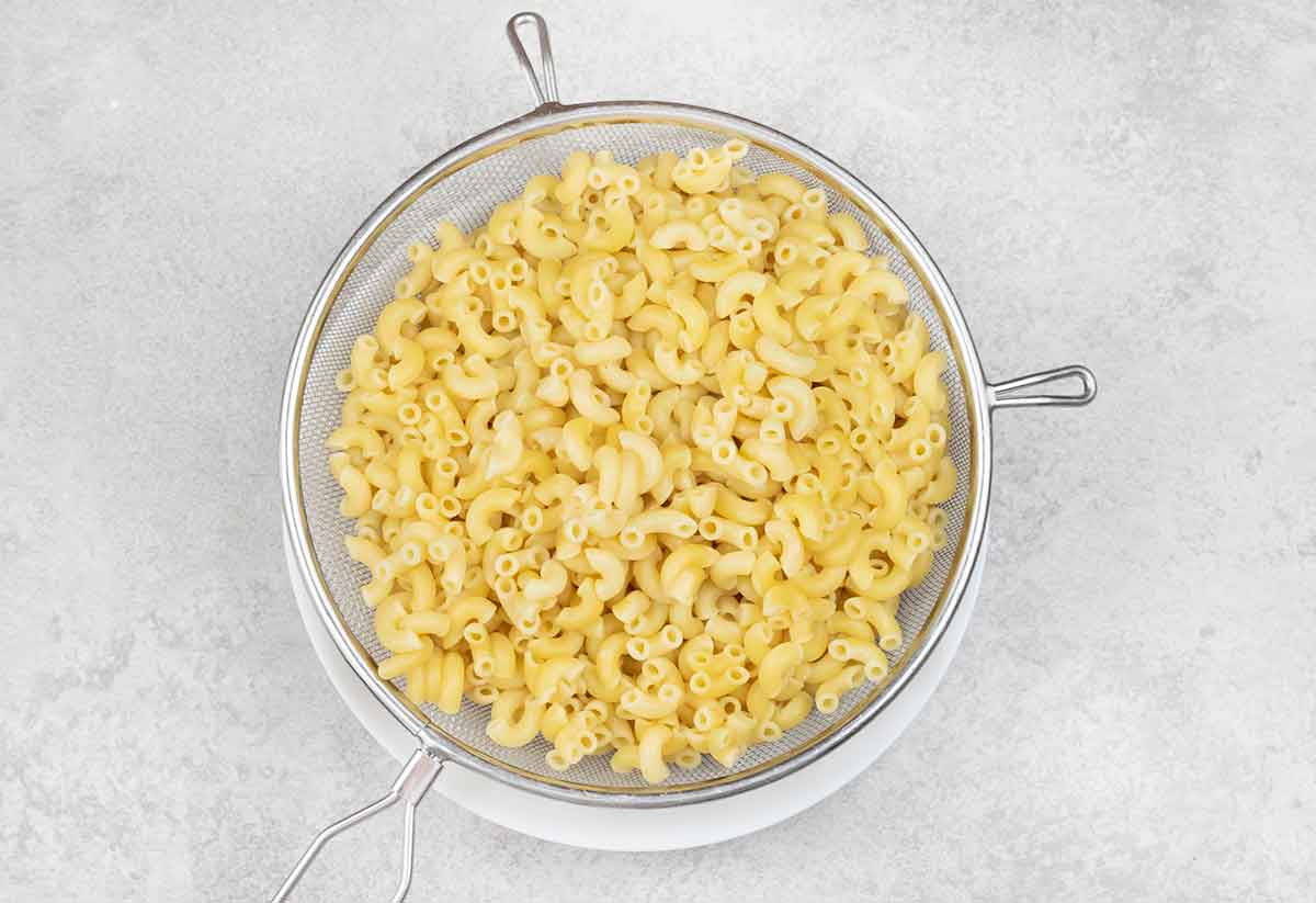 Cooked pasta in a colander.