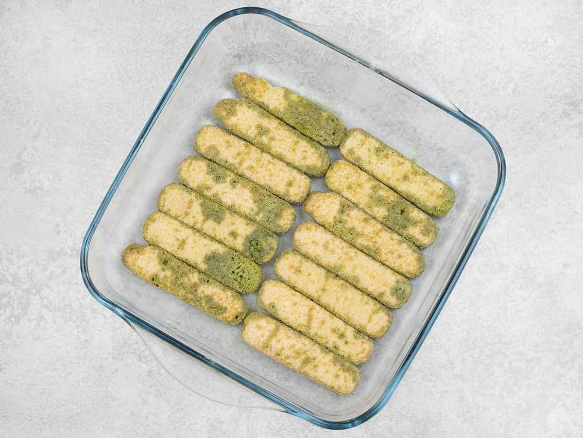 dipped ladyfingers into the matcha soak and arranged them in the dish.