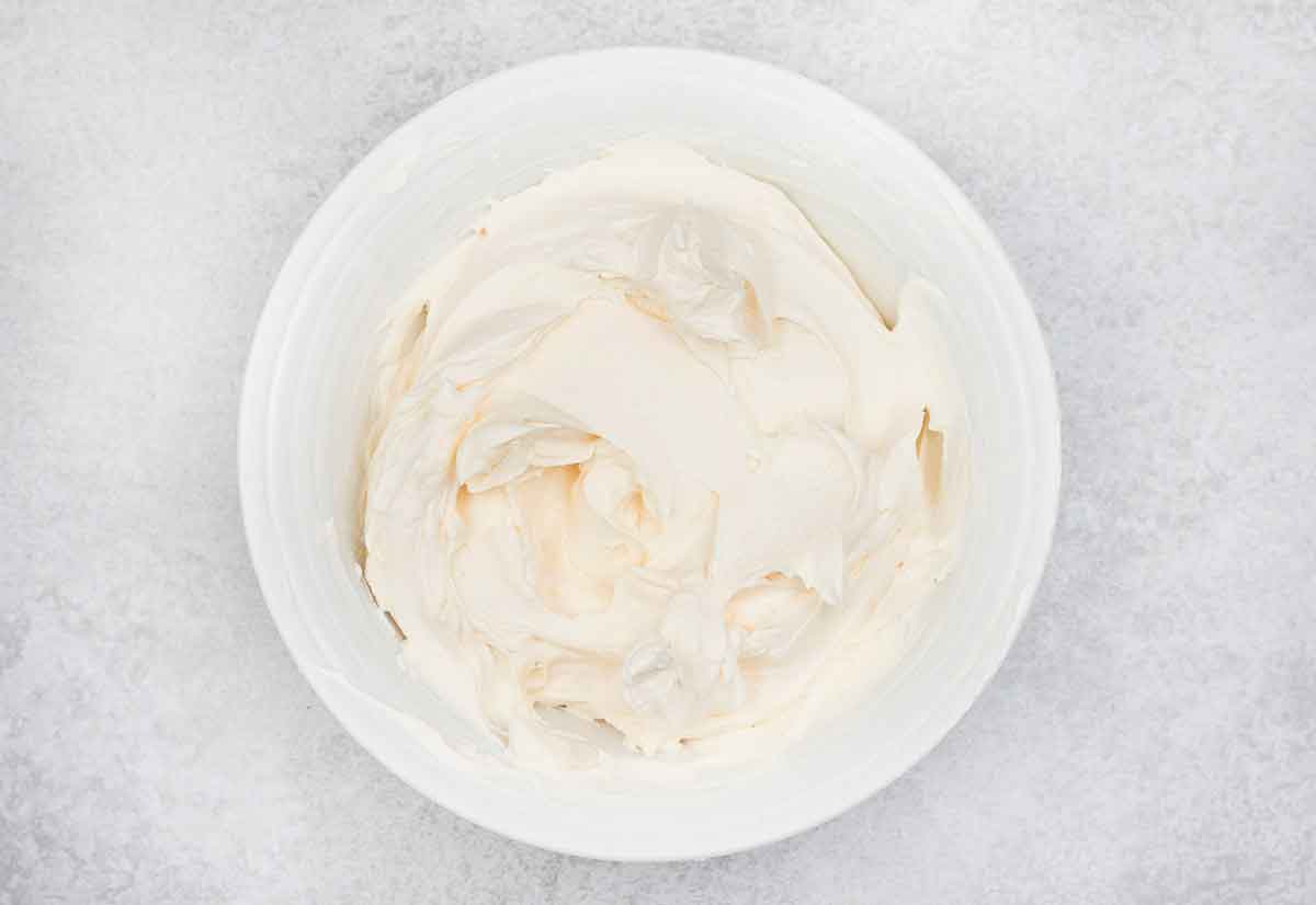 mixed mascarpone, sour cream and custard powder in a bowl.