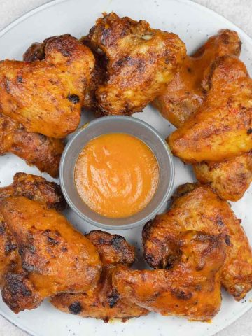 Crispy mango pepper wings served with dipping sauce.